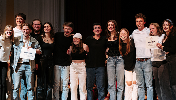 BBT stands on stage after accepting their award