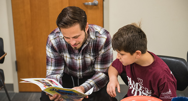 A teacher reads to a student.