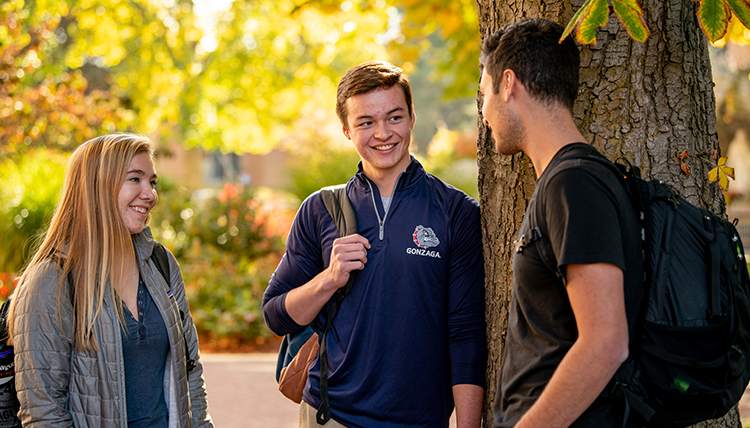 students in conversation on campus