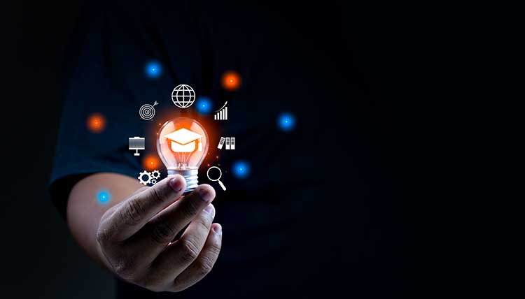 A hand holds a lightbulb with visual representations of ideas. The background is black.