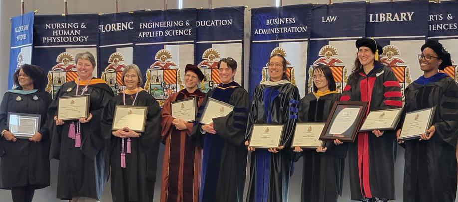 Faculty award winners facing forwards with awards