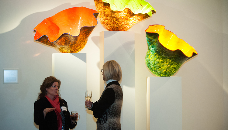 Visitors in front of Chihuly a glass exhibit at a special event in the Jundt Art Museum