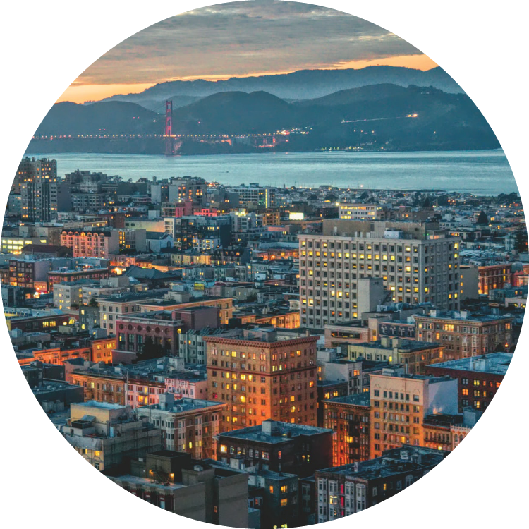 The San Francisco cityscape is bathed in twilight turquoise and orange with the Golden Gate Bridge just visible in the far left.