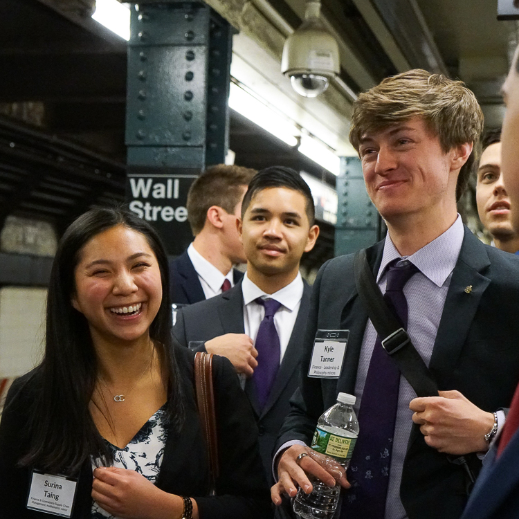 Students attending the New York trek smile at the camera as they navigate the subways.