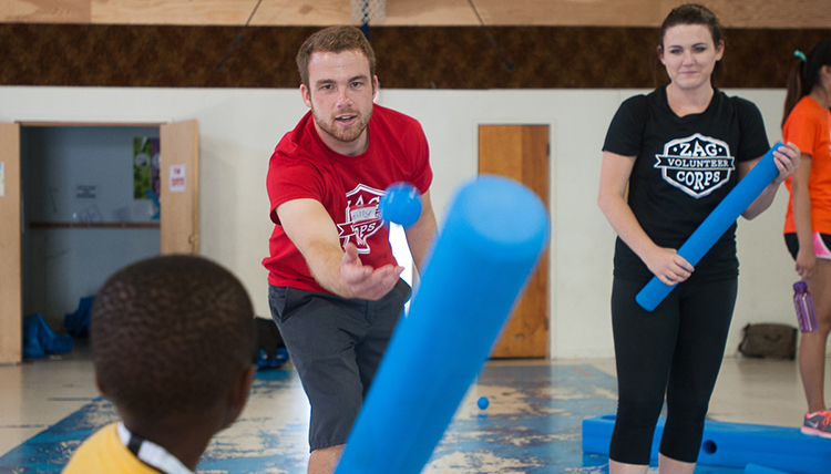 Members of the Zag Volunteer Corps play with children at the Boys and Girls Club.