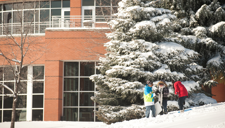 Students sledding in the winter.