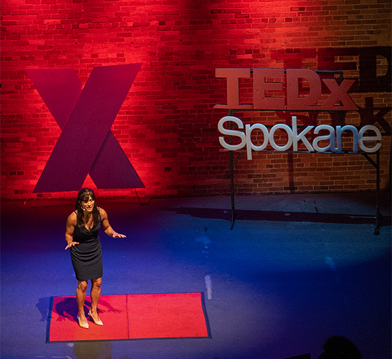 A presenter on the TEDx Spokane stage.