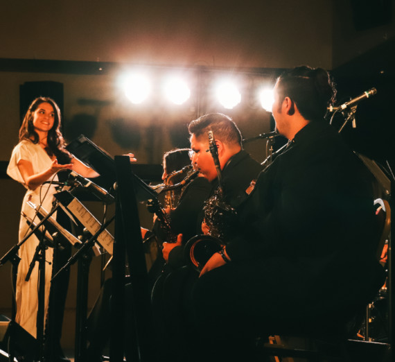 Several Big Band members on stage performing.