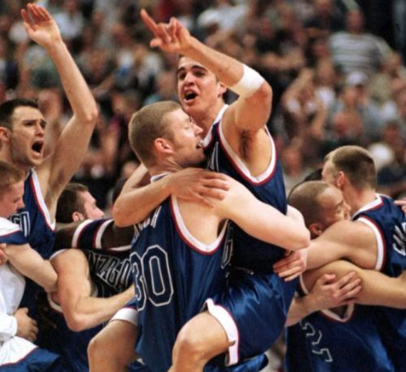 Several members of the 1999 Gonzaga Men's Basketball Team celebrating-one player is holding another player.