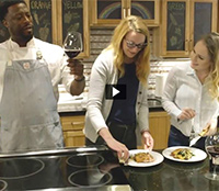 Three people enjoy a wine and food pairing.