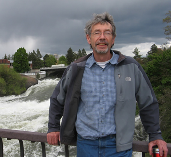 Mike Petersen stands on a bridge overlooking the Spokane Falls