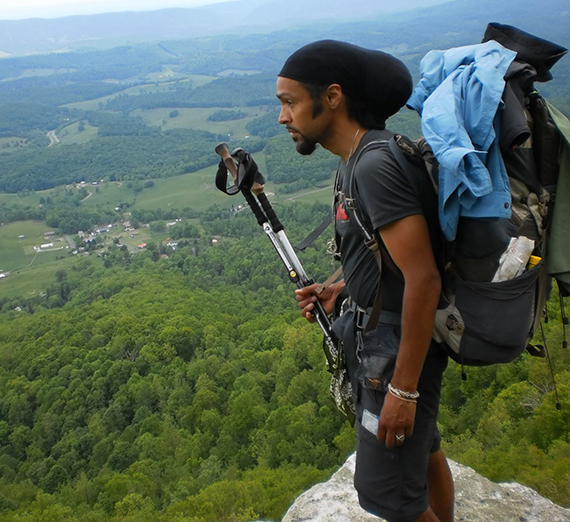 Author Derick Lugo looking over a view of the horizon while hiking.