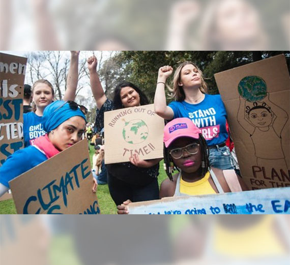 Girls holding climate signs
