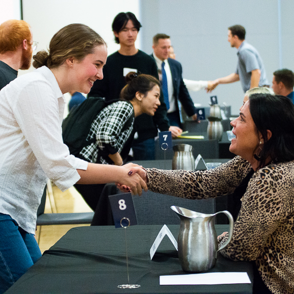 A student shakes hand with an employer representative at the 2022 Speed Mock Interviews
