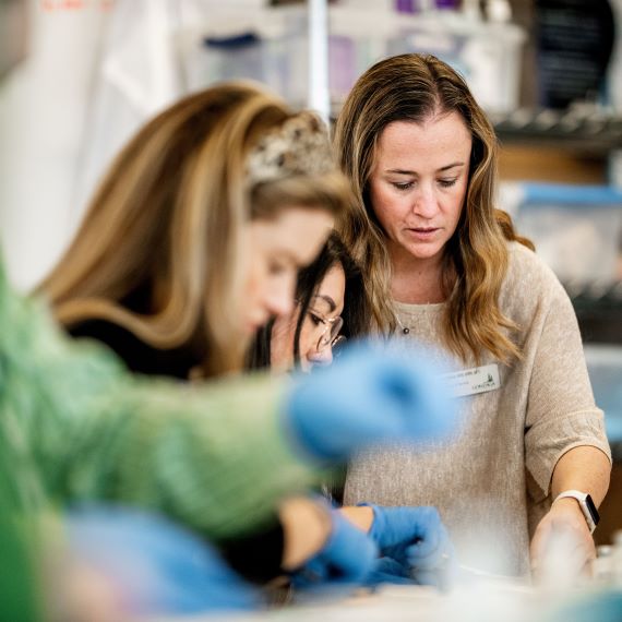 Nursing students learn how to suture a wound