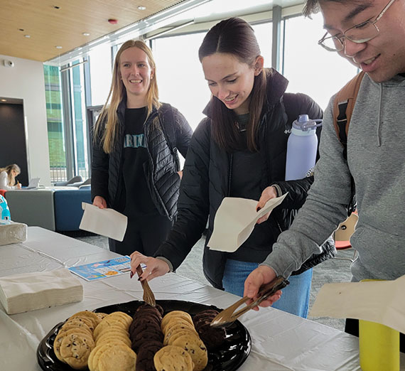 students picking up cookies