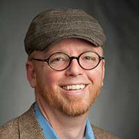 brian poses with a charcoal background