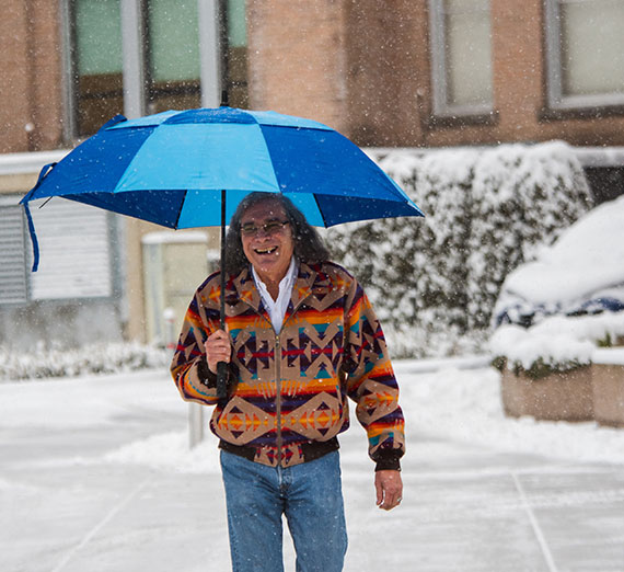 Raymond Reyes walking in the snow.