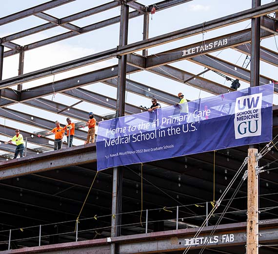 Beam lowers during the construction of the UW-GU Health Partnership building