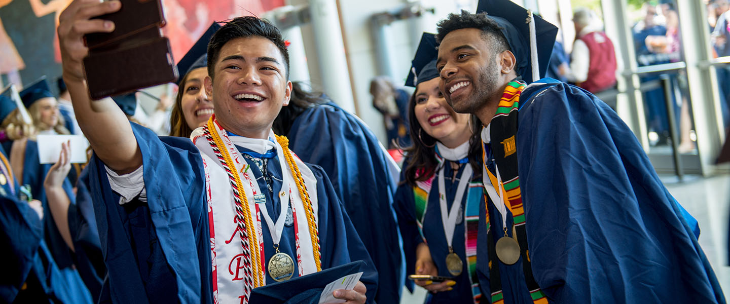 Graduates celebrating with a selfie photo.