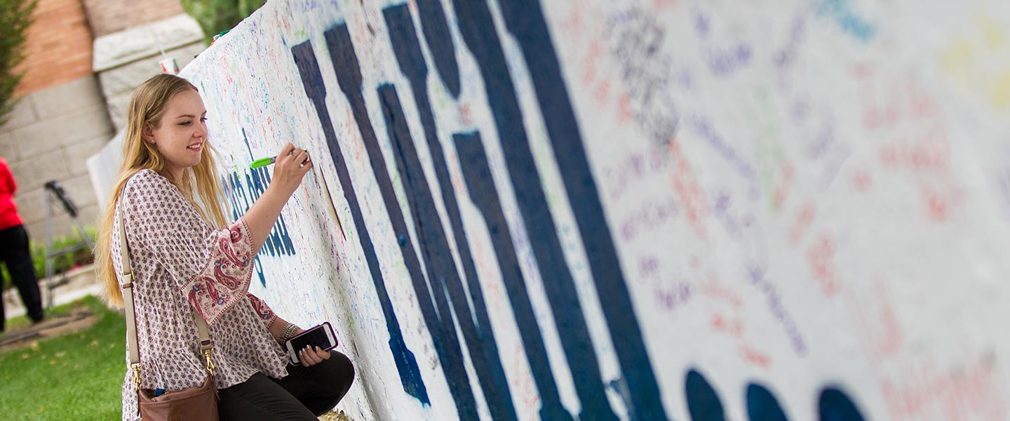 student paints wall for orientation 