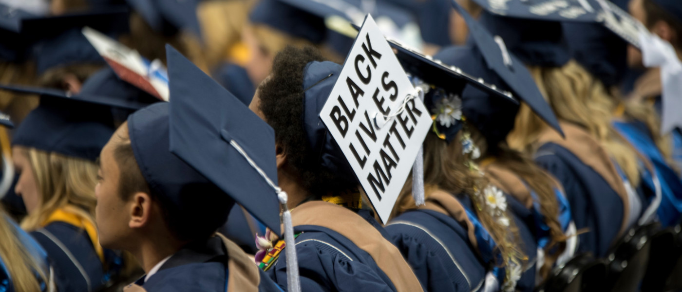 Student at commencement ceremony with a graduation cap that says "Black Lives Matter"