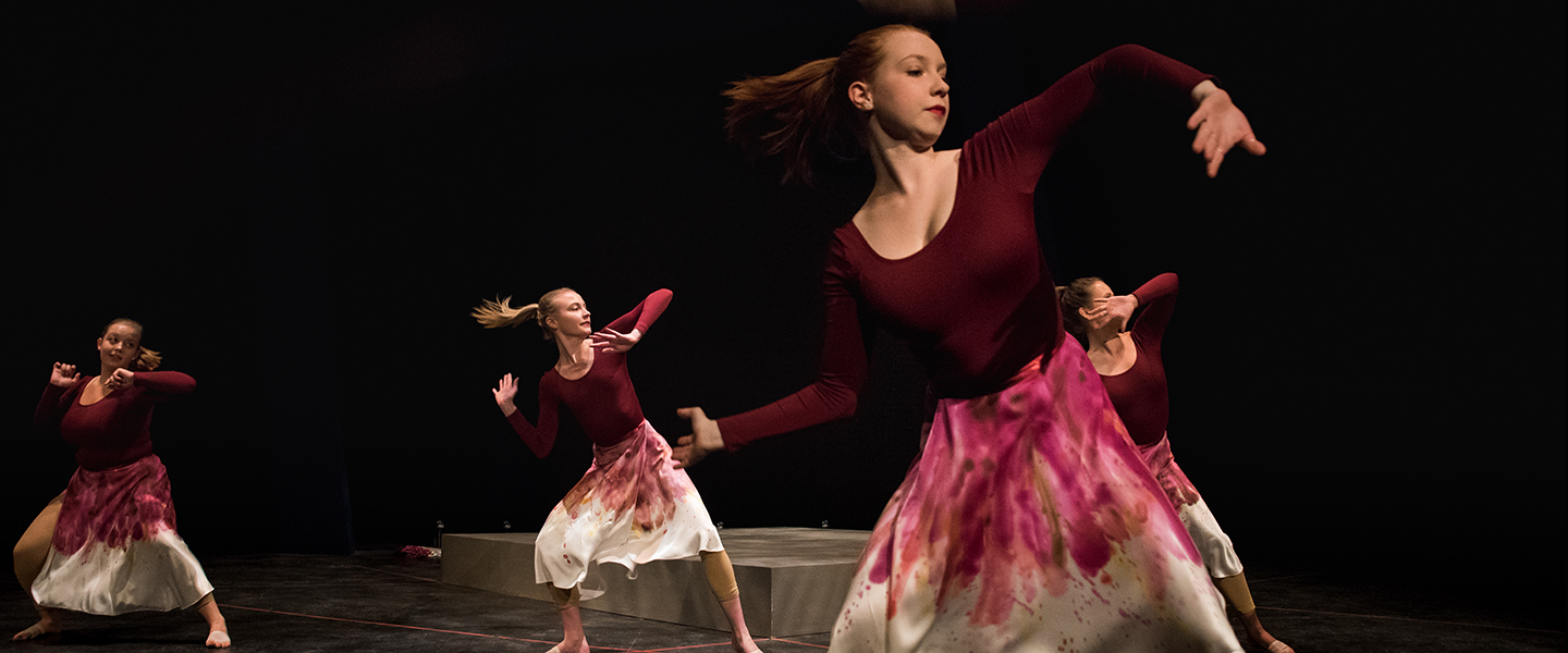 4 dance students are in motion performing a dance.