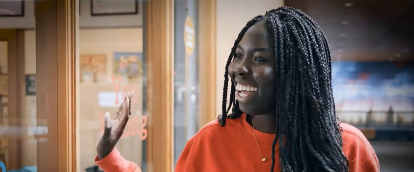 Akon Edwang smiling and waving at someone