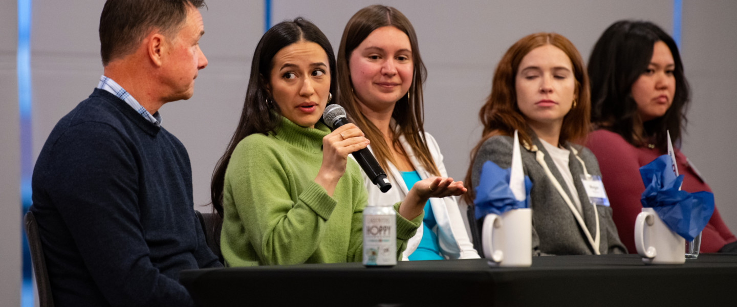 Sydney Schmidt, Gonzaga Mathematics alum at an alumni event with two other people. 
