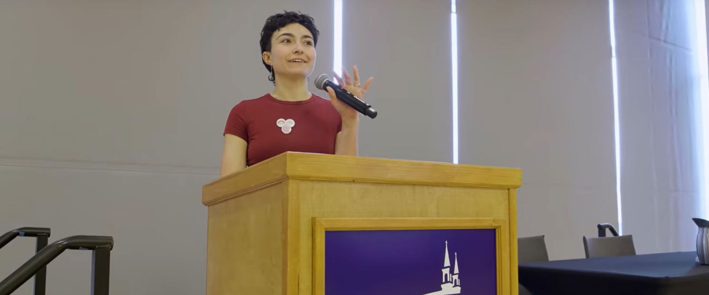 Student speaking at a podium