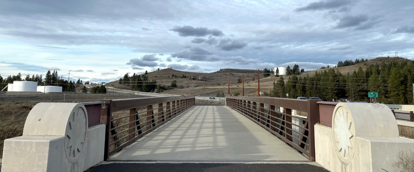 A bridge on the Children of the Sun Trail with sun icons in the concrete on each side of the bridge.