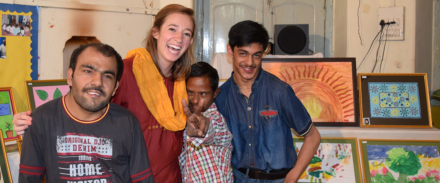 Katie Moore poses for a photo with students at the Deva Center in Varanasi, India