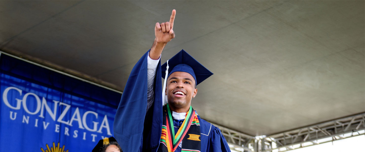 A student pointing to the crowd during the 2021 Gonzaga University Commencement ceremony