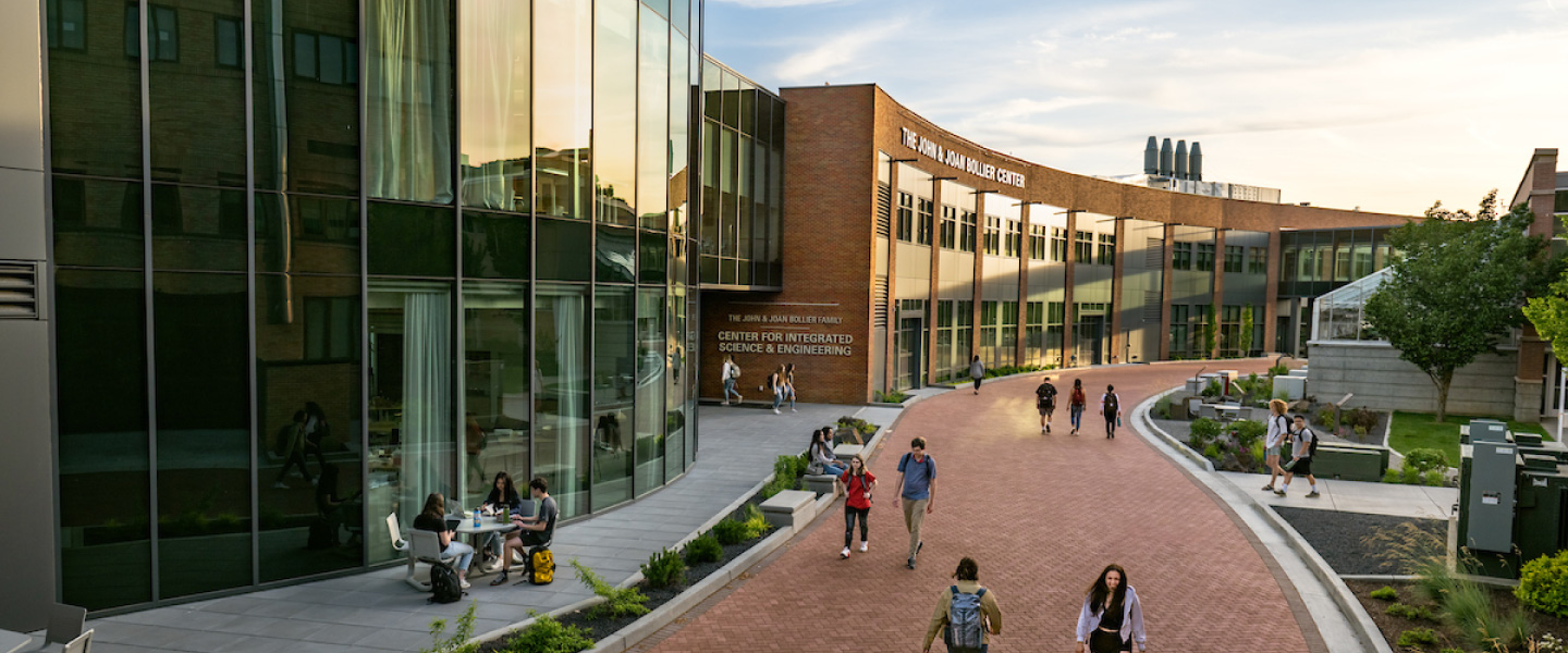 Students walk along a brick path in front of the Bollier Center located on the Gonzaga University campus 