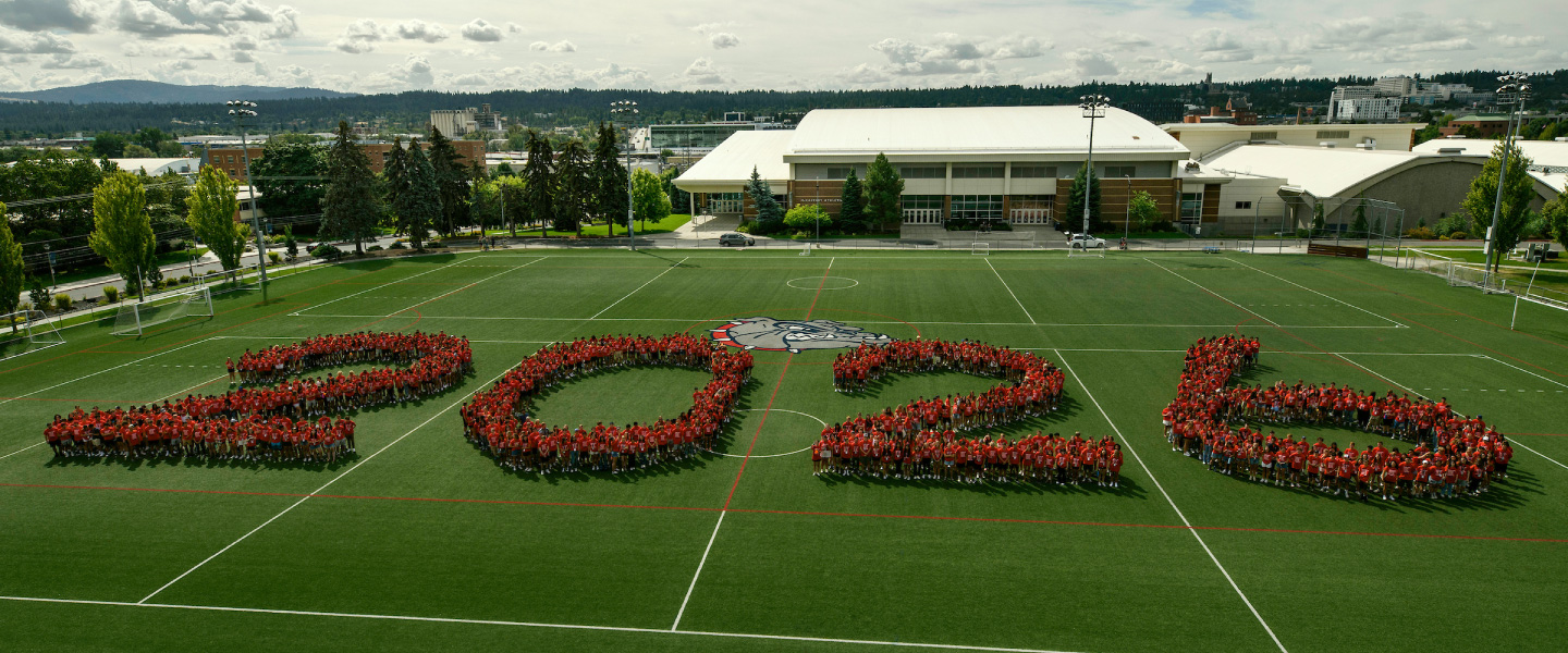 Gonzaga student stand together forming the number "2026" on a field.