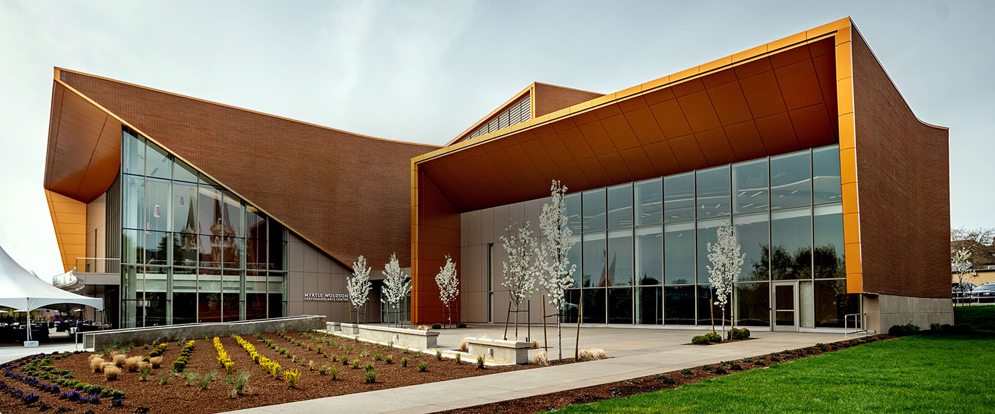 Exterior of Myrtle Woldson Performing Arts Center showing Recital Hall, lobby windows, and landscaped plaza