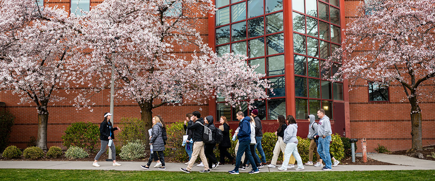 A campus tour walks by Foley Library.