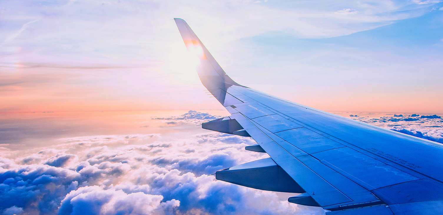 An airplane wing at sunset.