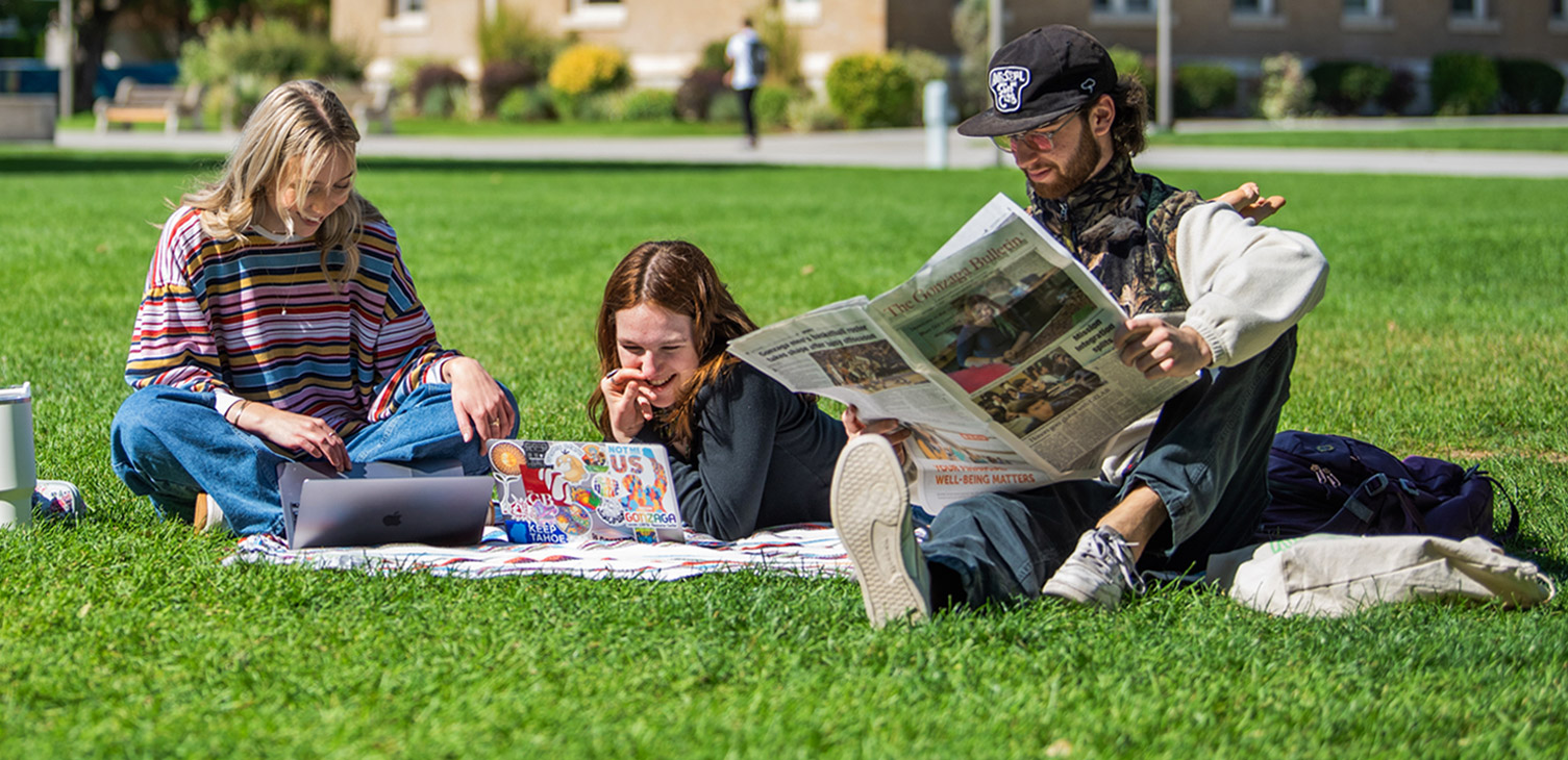 Gonzaga students hang out on the lawn in front of DeSmet Hall.
