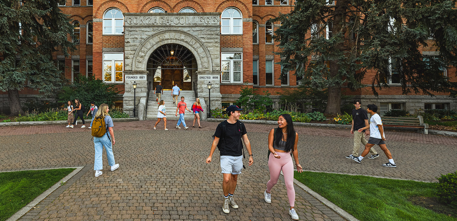 Students walk in front of College Hall on Gonzaga's campus.