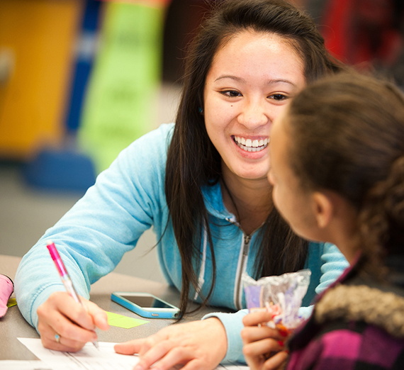 A Gonzaga student helps a young student with homework.