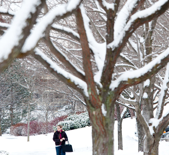student walking on campus in the snow 