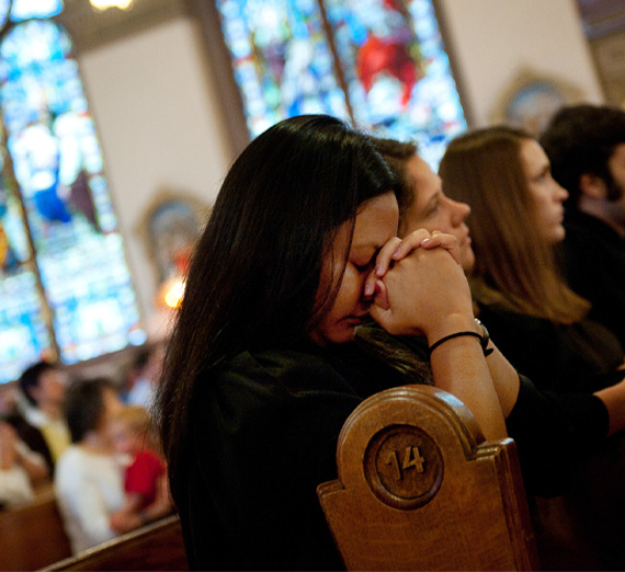student praying in church