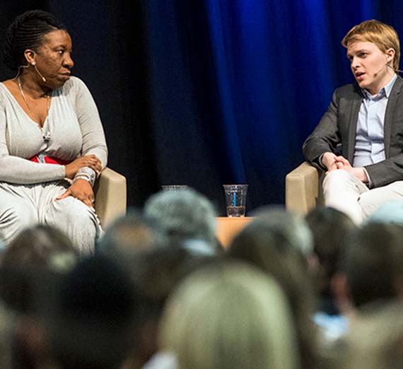 Tarana Burke and Ronan Farrow on a stage.