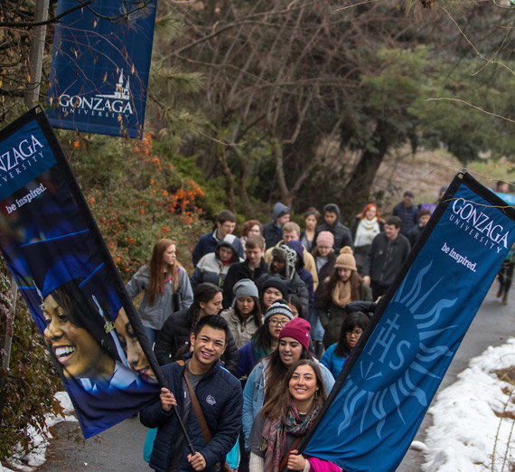 Students marching with Gonzaga flags