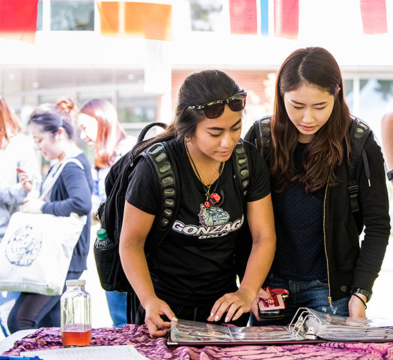 Two students attend a CGE fair.