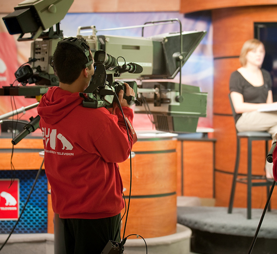 A GUTV student camera man filming on set.