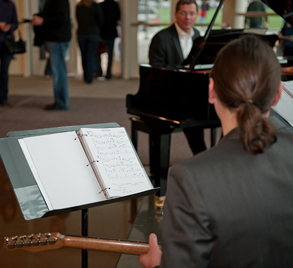 A guitarist and pianist get ready to play