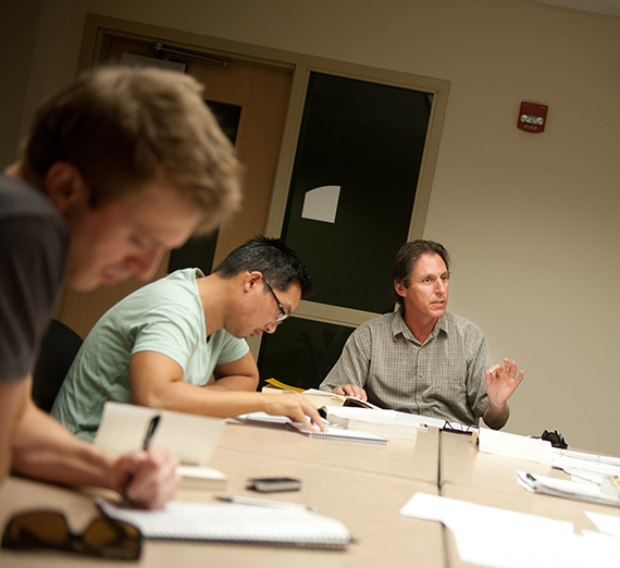 Students take notes in a Philosophy class lecture