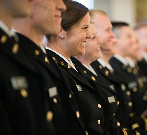 ROTC graduates in a line wearing dress uniforms.